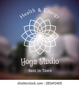 Yoga ornamental emblem on blurred background. Vector lineart logo template for relax or spa center, yoga studio, healthcare and traditional medicine
