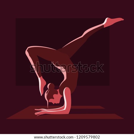 A yoga practitioner stands in an asana with his head down on a special mat. Fitness, yoga.