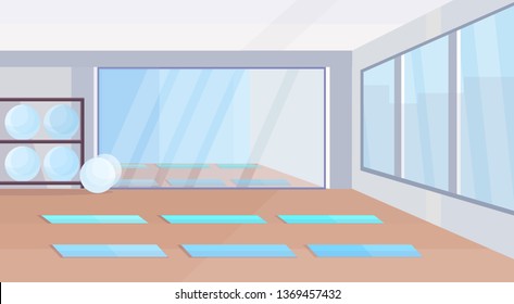 yoga studio healthy lifestyle concept empty no people gym interior design with mats fit balls mirror and windows horizontal