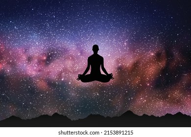 Yogi girl fly in lotus pose. Woman meditating at nature. Starry sky