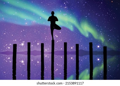 Yogi standing on log. Man doing yoga at starry night. Polar Lights