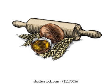 Yolk in the eggshell, egg, wheat spikelets and rolling pin