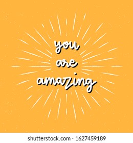 You are amazing hand lettering with sunburst lines on yellow background.