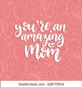 You Are An Amazing Mom vector calligraphic inscription. Happy Mother's Day hand lettering illustration on abstract background for greeting card, festive poster etc.