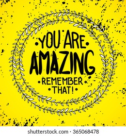 You are  amazing. remember that. Inspirational quotes written in a wreath by hand, for writing on posters, T-shirts and cards. Vector calligraphy, isolated on white background