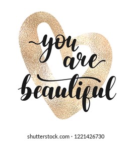 You are beautiful - black hand written lettering with golden heart shape isolated on white background. Modern vector design, decorative inscription, motivational poster.