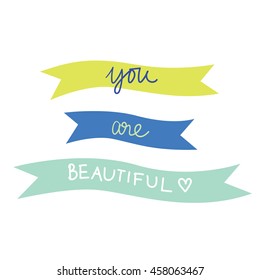 "You are beautiful" Hand drawn lettering in colorful ribbon. Cute calligraphy. Isolated on white background. Compliment for women.