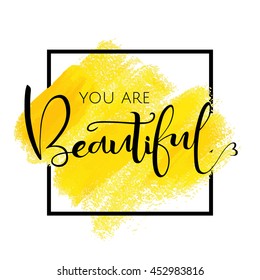 You are beautiful, inspirational phrase of black color in the frame. Yellow brush strokes with rough edges. Vector illustration. Hand drawn element for your design.