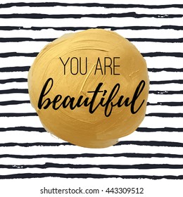 You are beautiful. Inspirational quote on a golden watercolor background stain