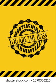 You are the Boss black grunge emblem, yellow warning sign. Vector Illustration. Detailed.