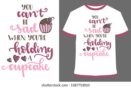 "you can't be sad when you're holding a cupcake" - typography t-shirt vector design illustration, it can use for label, logo, sign, sticker for printing for the family t-shirt.
