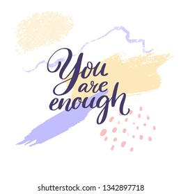 You are enough. Inspiration saying handwritten on purple and yellow ink stroke.