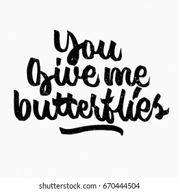 You give me butterflies quote. Ink hand lettering. Modern brush calligraphy. Handwritten phrase. Inspiration graphic design typography element. Cute simple vector sign.