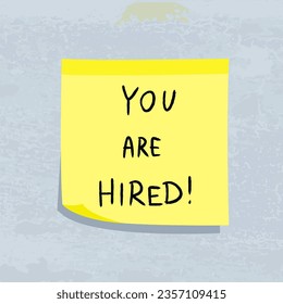 You are hired message. Career and employment concept. Yellow sticky note message. Paper sign.