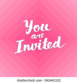 You are invited card with hand drawn lettering design with polka dots pattern on background.