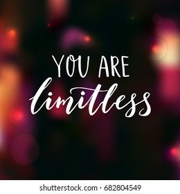 You are limitless. Encouraging quote. Motivational saying, brush lettering on dark background with pink bokeh