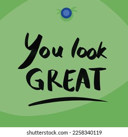 You look great text. Hand written note with black marker on square green paper and blue push pins decoration. Cute simple text note to not worrying. Sticky paper design.