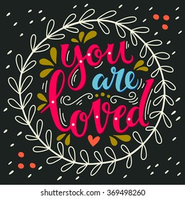You are loved. Hand lettering in wreath with decoration elements. This illustration can be used as a greeting card for Valentine's day or wedding or as a print or poster.