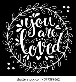 You are loved. Hand lettering in wreath with decoration elements. This illustration can be used as a greeting card for Valentine's day or wedding or as a print or poster.