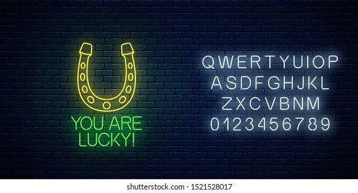 You are lucky - glowing neon inscription phrase with horseshoe sign with alphabet on dark brick wall background. Motivation quote in neon style. Vector illustration.