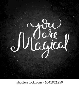 You are magical. Hand written calligraphy quote motivation for life and happiness on blackboard. For postcard, poster, prints, cards graphic design.