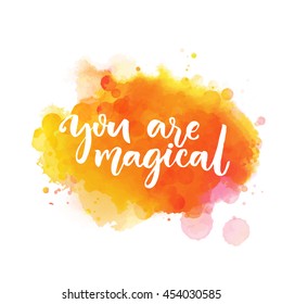 You are magical. Inspiration saying lettering on bright orange watercolor paint stain. Vector phrase for greeting cards, wall art