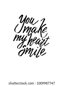 You make my heart smile Valentines day calligraphy card. Hand drawn design elements. Handwritten modern brush lettering.