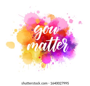 You matter - motivational message. Handwritten modern calligraphy inspirational text on pink and purple colored watercolor paint splash.