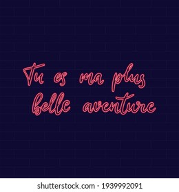 You are my the most beautiful  adventure. Neon Inspirational phrase. Calligraphic hand lettering motivational inscription in french language for postcard, poster, wallpaper. Vector illustration.