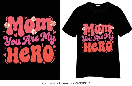 Diseño de camiseta "Mamá eres mi héroe" con letras redondeadas, acentos florales y detalles de corazón. Gráfico de mamá brillante, alegre y centrado en el aprecio.