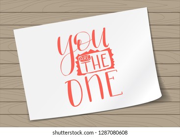 You are the One - Hand Drawn Lettering on A4 White Paper on Wooden Background . Live Coral Vector Illustration Quote. Inscription Phrase for Valentine Day Greeting Card Design, Celebration.