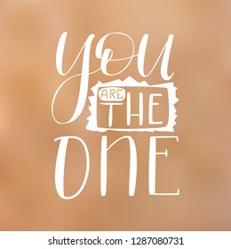You are the One - White Hand Drawn Lettering on Blur Background. Vector Illustration Quote. Handwritten Inscription Phrase for Valentine Day Greeting Card Design, Celebration.