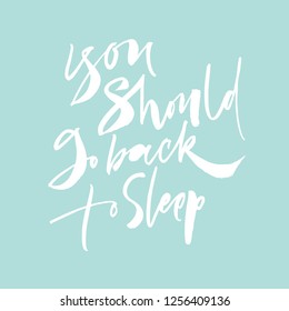 You should go back to sleep lettering on blue background. Calligraphy phrase 