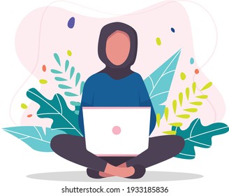 Young, active, happy, strong girl in a hijab, student working or studying in a laptop.
. A teenager sits in a lotus pose with a laptop. Background tropical plants. international student