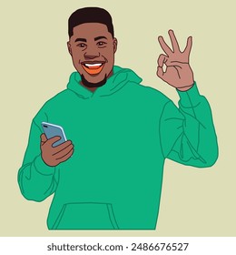 Young African American man smiling with his phone wearing a green hoody.