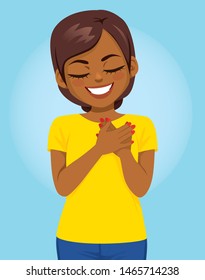 Young African American woman with hands on heart making lovely grateful face expression gratitude gesture