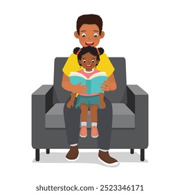 Young African father read book with his son sitting on couch