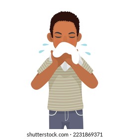 Young African man with runny nose holding a handkerchief or tissue sneezing and blowing because of fever, cold, flu, allergy, virus infection