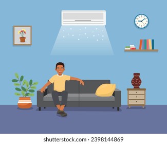 Young African man sitting on sofa relaxing enjoying under air cooling with Air Conditioner at home