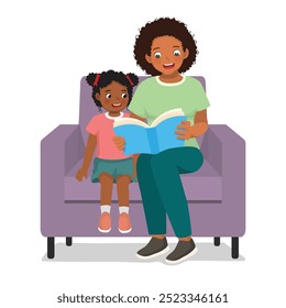 Young African mother read book with her daughter sitting on couch