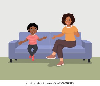 Young African mother talking to her son sitting on sofa giving advises encouragement and support 