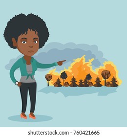 Young african woman pointing at the forest in fire. Frustrated woman standing on the background of a big forest fire. Concept of environmental destruction. Vector cartoon illustration. Square layout.