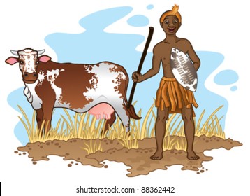 Young African Zulu man in traditional dress with cow