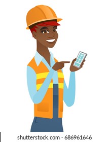 Young african-american builder holding mobile phone and pointing at it. Cheerful builder in hard hat using a mobile phone. Vector flat design illustration isolated on white background.