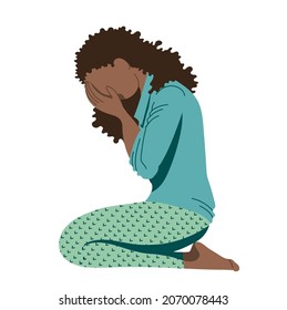 Young African-American girl, a teenager suffering from psychological illnesses, depression, anxiety, is sitting on the floor, covering her face with her hands and lowering her head