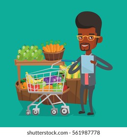 Young african-american man checking shopping list. Smiling man holding shopping list near trolley with products. Happy man writing in shopping list. Vector flat design illustration. Square layout.