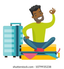 Young african-american man sitting on a suitcase full of clothes and trying to close it. Happy man packing a lot of clothes into a single suitcase and showing ok sign. Vector cartoon illustration.