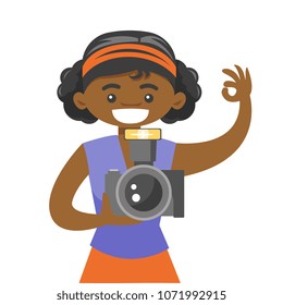 Young african-american photographer taking a photo. Happy female photographer holding a digital camera and showing ok sign. Vector cartoon illustration isolated on white background. Square layout.