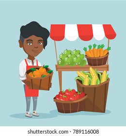 Young african-american street seller selling fruits and vegetables. Street seller standing near the market stall and holding a basket of oranges. Vector cartoon illustration. Square layout.