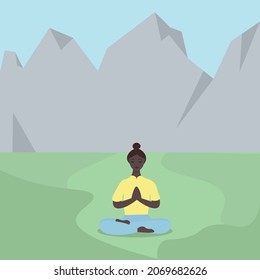 A young African-American woman does yoga among the mountains. The girl is sitting in the lotus position in nature. Playing sports on the street. Relaxation and detox from city life